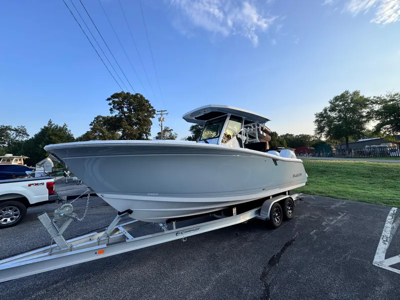 Slide: The Image of 2025 Blackfin 272 CC boat on trailer in parking lot, clear sky background. - 3