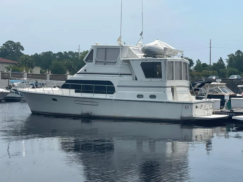 Slide: The Image of 2005 Novatec 48 Cockpit Motor Yacht docked in a marina. - 1