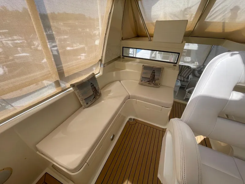 Slide: The Image of 2005 Novatec 48 Cockpit Motor Yacht interior with beige seating and decorative pillows. - 13