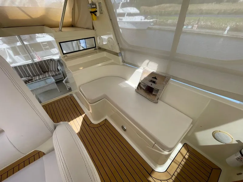 Slide: The Image of 2005 Novatec 48 Cockpit Motor Yacht interior with seating and wooden flooring. - 14