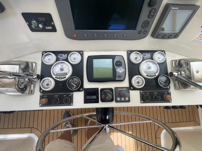 Slide: The Image of Control panel of a 2005 Novatec 48 Cockpit Motor Yacht with gauges and navigation equipment. - 16