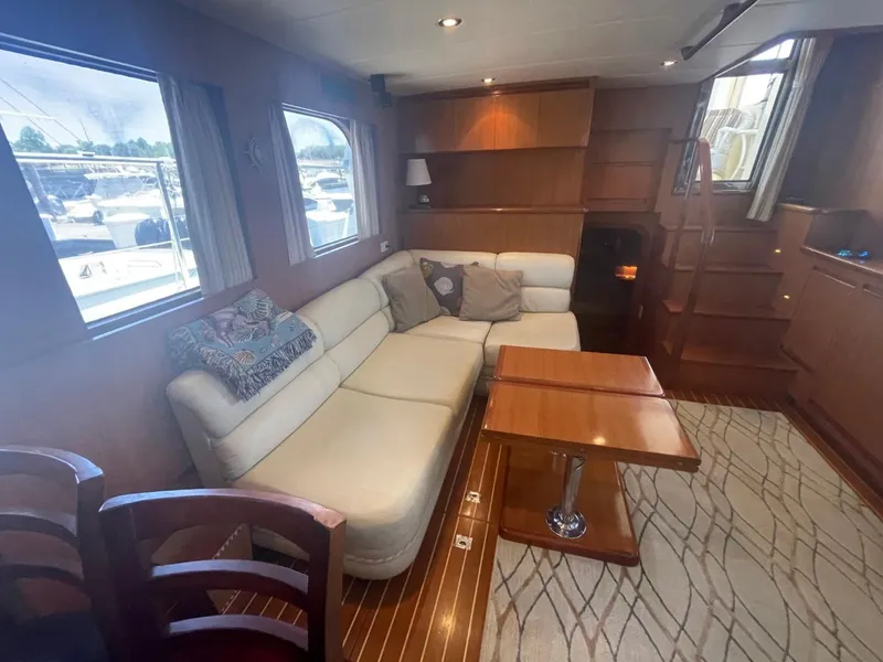 Slide: The Image of Luxurious interior of 2005 Novatec 48 Cockpit Motor Yacht with cozy seating and wooden accents. - 24