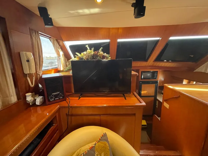 Slide: The Image of Luxurious 2005 Novatec 48 Cockpit Motor Yacht interior with TV and elegant wood finish. - 25