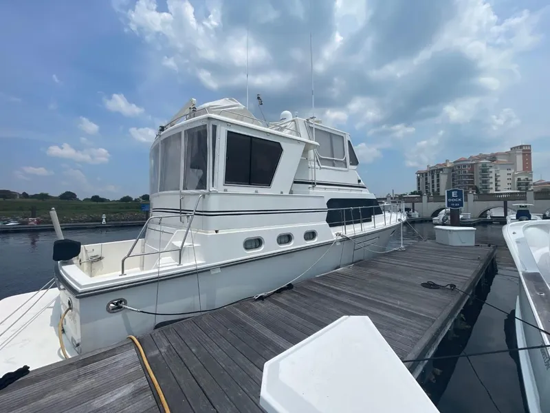 Slide: The Image of 2005 Novatec 48 Cockpit Motor Yacht docked under cloudy sky. - 3