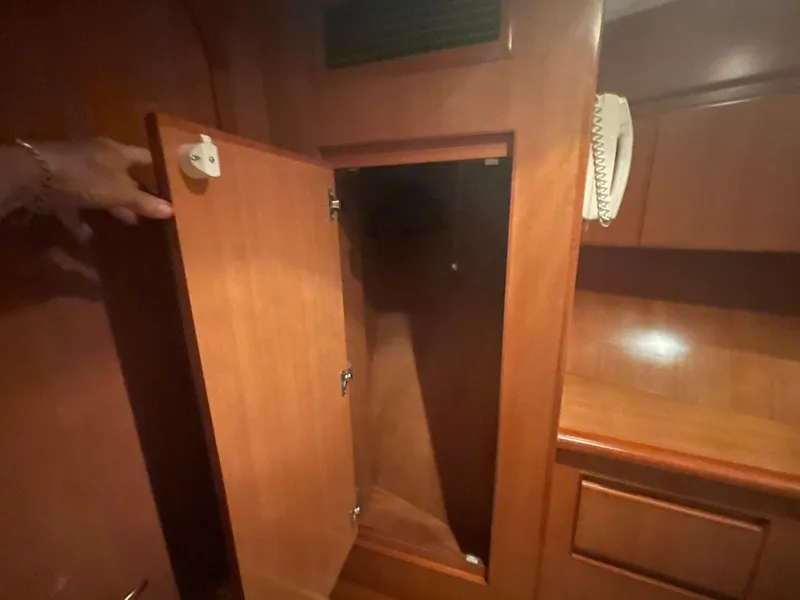 Slide: The Image of Open wooden cabinet inside 2005 Novatec 48 Cockpit Motor Yacht interior. - 31