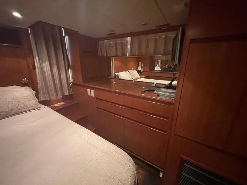 Slide: The Image of Luxurious cabin interior of 2005 Novatec 48 Cockpit Motor Yacht with wood finish and cozy bedding. - 32