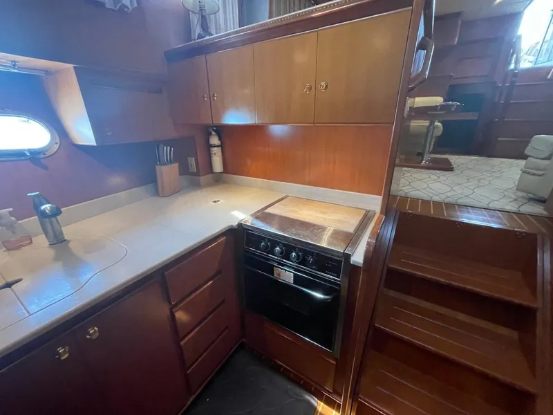 Slide: The Image of 2005 Novatec 48 Cockpit Motor Yacht kitchen with wood cabinetry and compact appliances. - 42