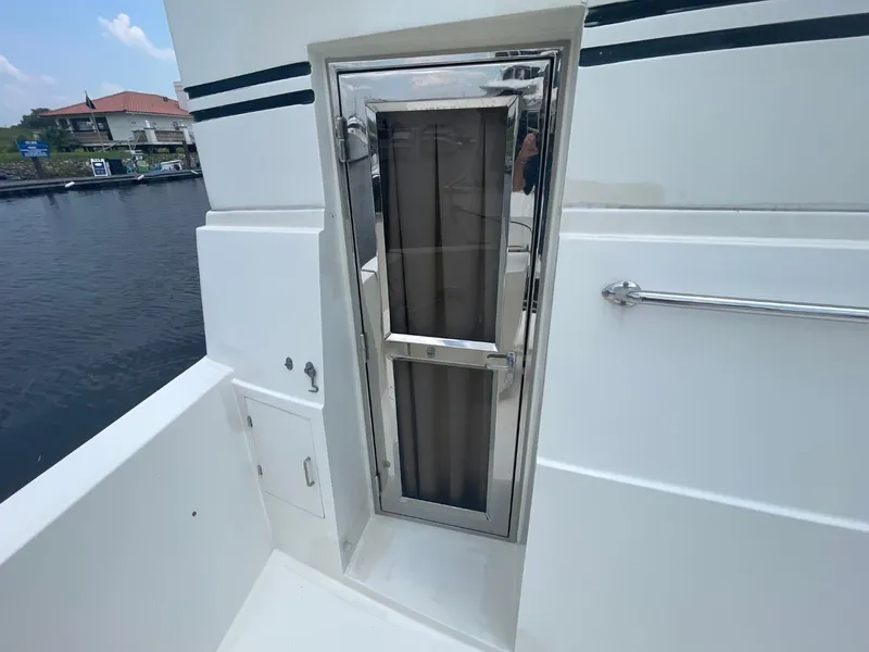 Slide: The Image of Novatec 48 Cockpit Motor Yacht 2005, exterior door detail with chrome finish. - 52