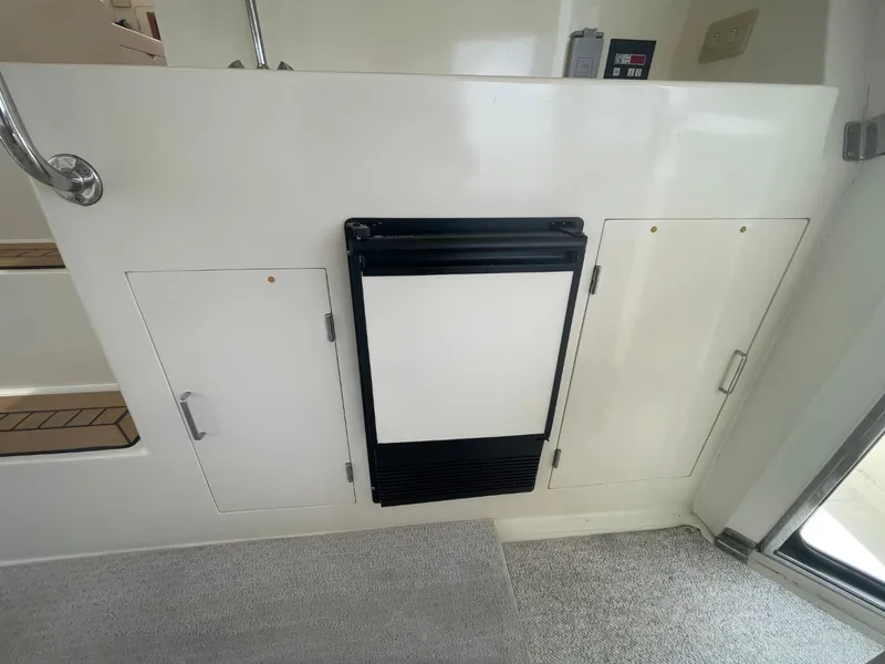 Slide: The Image of Interior of 2005 Novatec 48 Cockpit Motor Yacht with storage compartments and a mini fridge. - 53