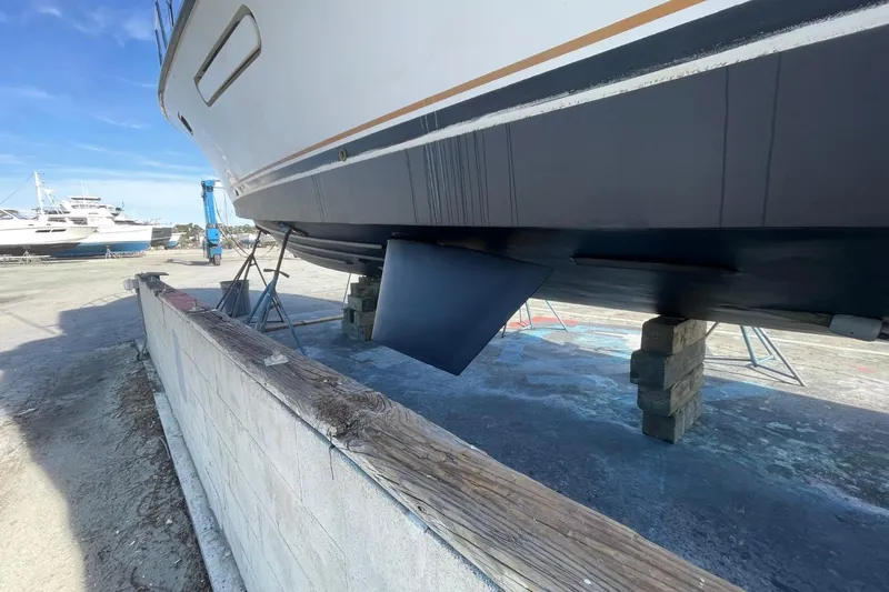 Slide: The Image of 2005 Novatec 48 Cockpit Motor Yacht on dry dock, showcasing hull and rudder. - 73