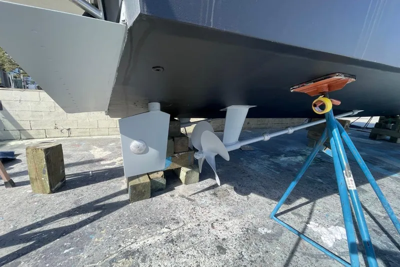 Slide: The Image of 2005 Novatec 48 Cockpit Motor Yacht under maintenance, showing propeller and hull details. - 79