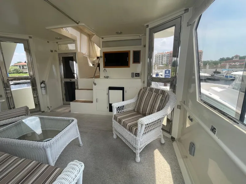Slide: The Image of 2005 Novatec 48 Cockpit Motor Yacht interior with wicker furniture and glass table. - 8