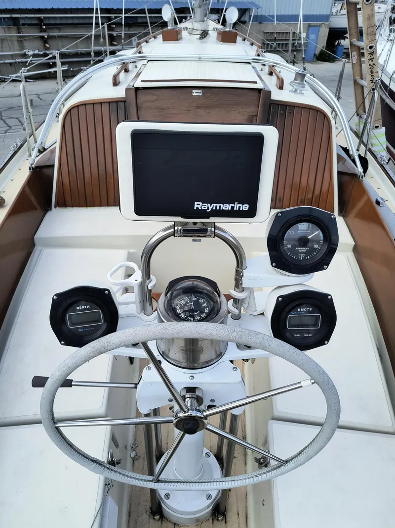 Slide: The Image of 1969 Chris-Craft Apache 37 yacht cockpit with steering wheel and navigation instruments. - 10