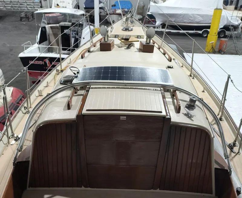 Slide: The Image of 1969 Chris-Craft Apache 37 boat with solar panel, docked indoors. - 15