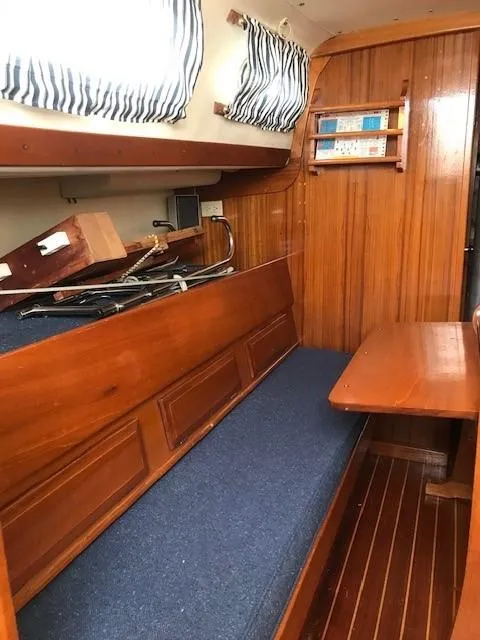 Slide: The Image of 1969 Chris-Craft Apache 37 interior with wooden paneling and blue cushioned seating. - 19
