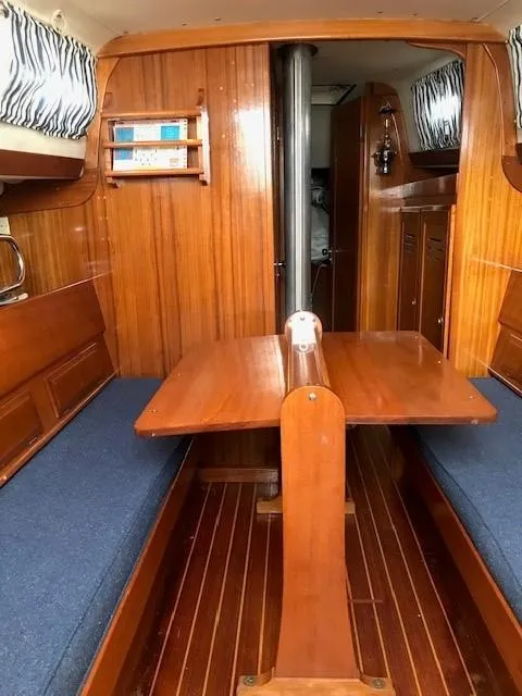 Slide: The Image of 1969 Chris-Craft Apache 37 interior with wooden dining area and blue cushions. - 20