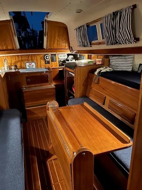 Slide: The Image of Interior of 1969 Chris-Craft Apache 37 boat with wooden furnishings and cozy seating area. - 21