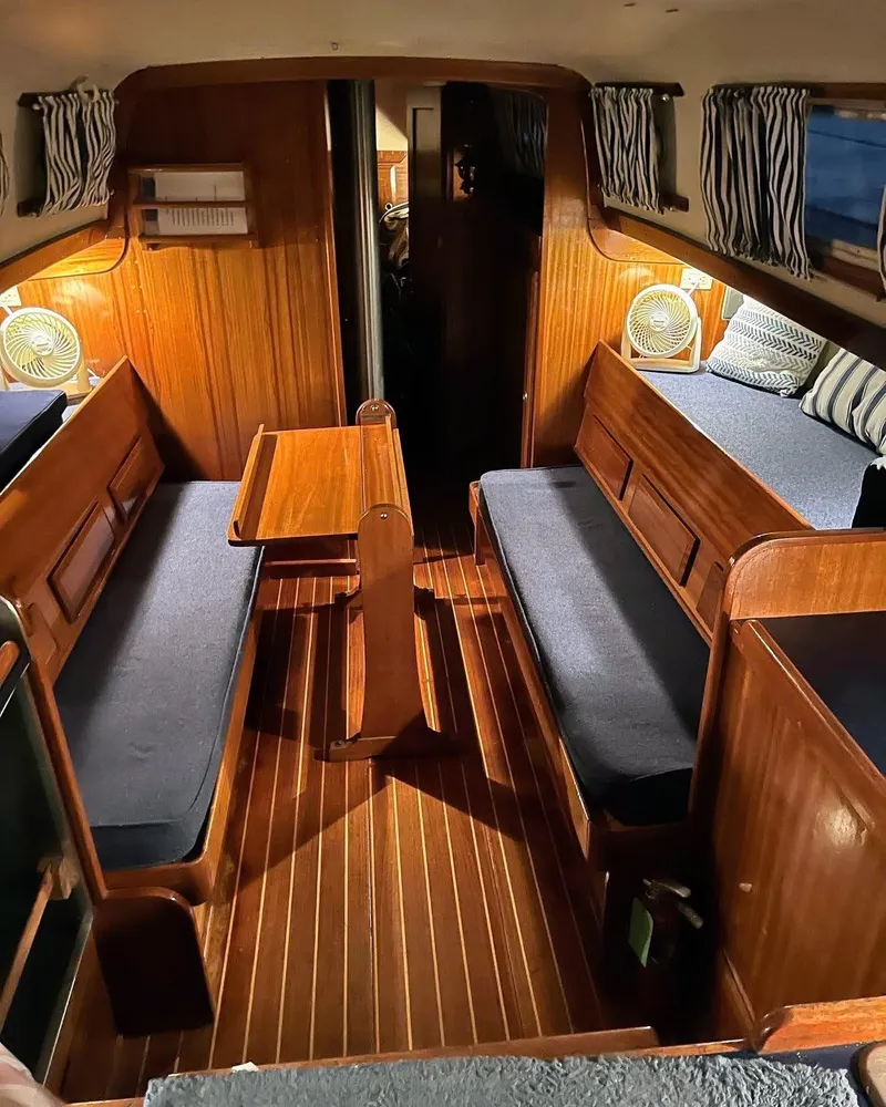 Slide: The Image of Interior of 1969 Chris-Craft Apache 37 boat with wooden furnishings and cozy seating. - 23