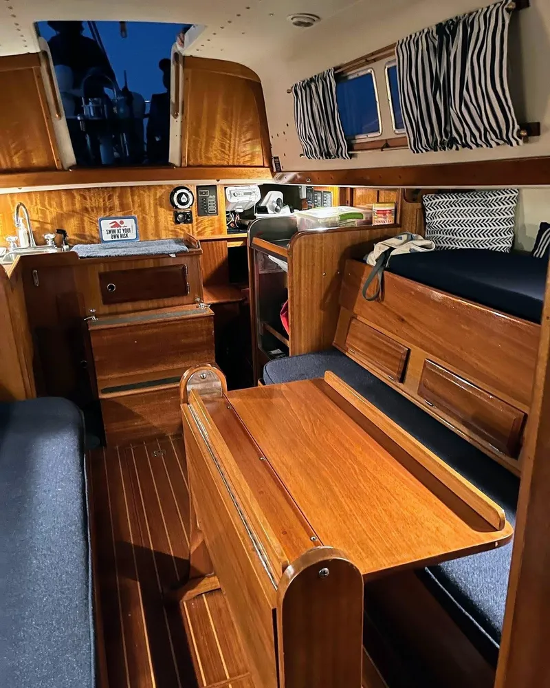 Slide: The Image of Interior of a 1969 Chris-Craft Apache 37 boat with wooden furnishings and cozy seating. - 24