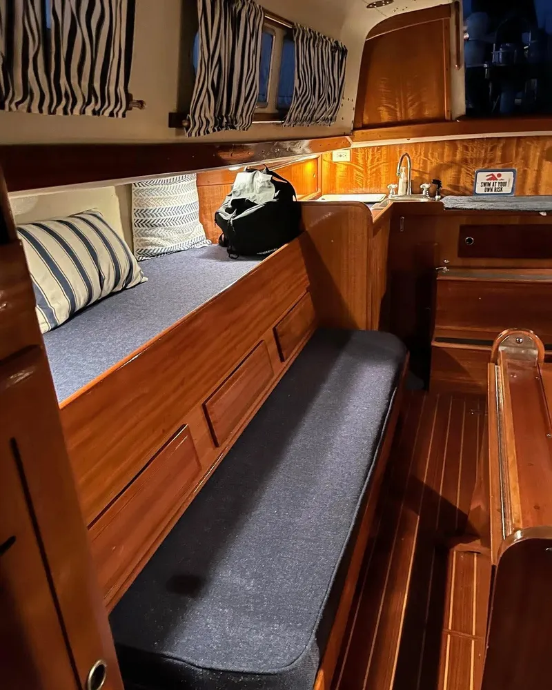Slide: The Image of Interior of 1969 Chris-Craft Apache 37 boat with wooden furnishings and cozy seating. - 25