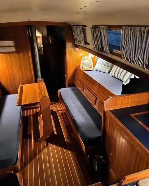 Slide: The Image of 1969 Chris-Craft Apache 37 interior with wood paneling and blue seating. - 26