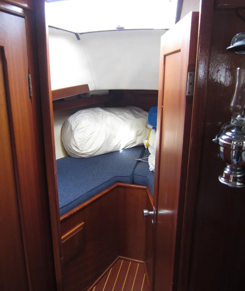 Slide: The Image of 1969 Chris-Craft Apache 37 cabin interior with wooden finish and cozy bedding. - 27
