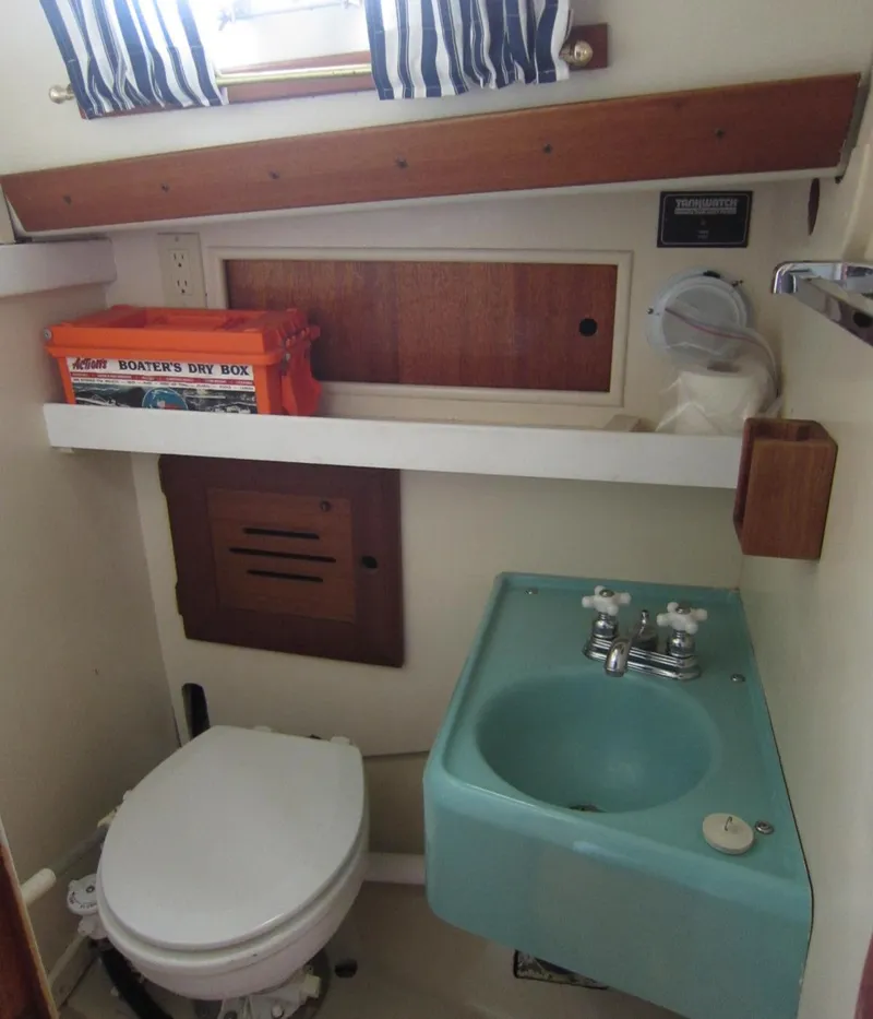 Slide: The Image of 1969 Chris-Craft Apache 37 boat bathroom with sink, toilet, and storage. - 29