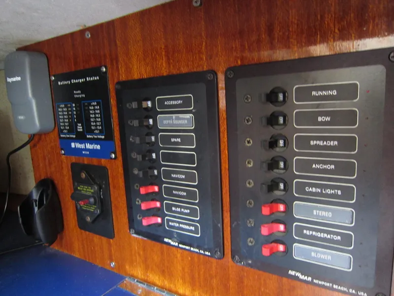 Slide: The Image of Control panel of a 1969 Chris-Craft Apache 37 boat with labeled switches and battery charger. - 33