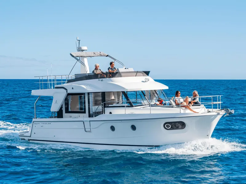 The Image of 2026 Beneteau Swift Trawler 41 Fly cruising on open sea under clear blue sky. - 0