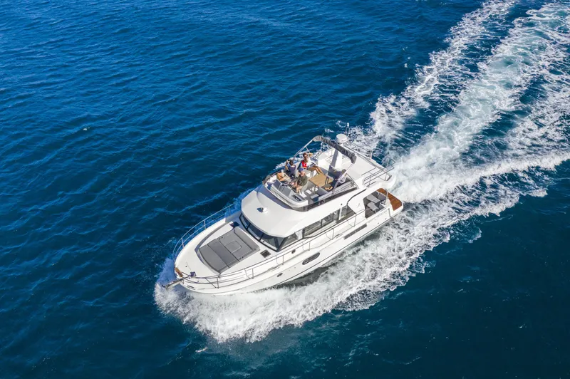 Slide: The Image of 2026 Beneteau Swift Trawler 41 Fly cruising on open blue sea. - 1