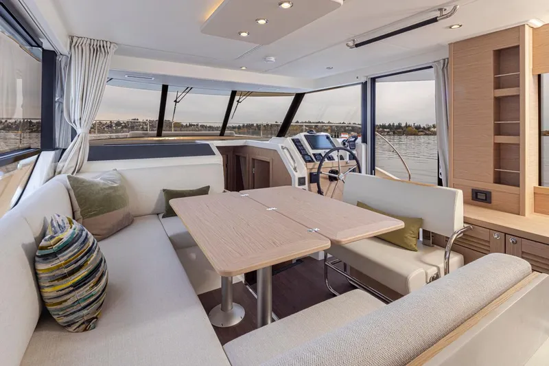 Slide: The Image of Interior of 2026 Beneteau Swift Trawler 41 Fly, featuring elegant seating and modern helm. - 10