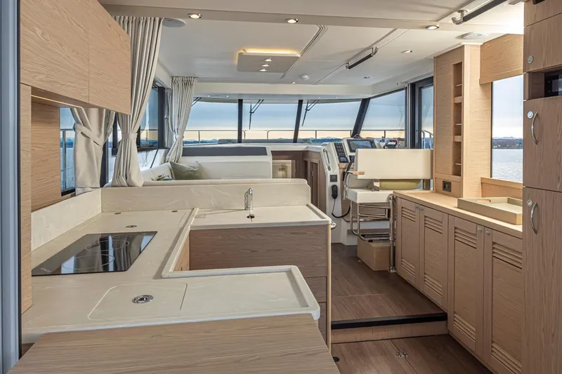 Slide: The Image of Interior of 2026 Beneteau Swift Trawler 41 Fly, featuring modern kitchen and helm station. - 13