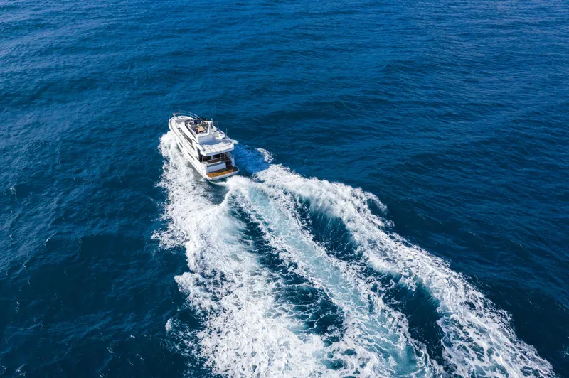 Slide: The Image of Beneteau Swift Trawler 41 Fly 2026 cruising on open blue sea. - 2