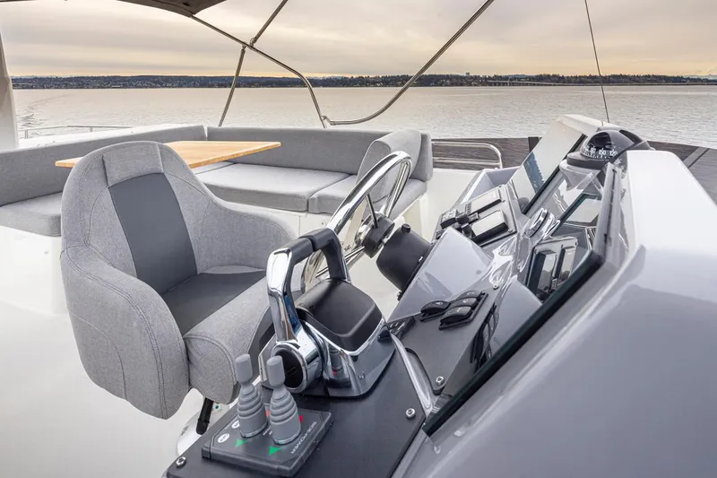 Slide: The Image of 2026 Beneteau Swift Trawler 41 Flybridge helm with modern controls and seating. - 21