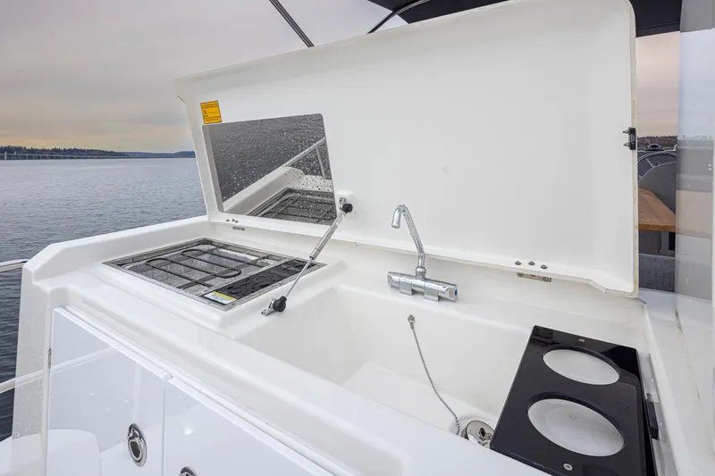 Slide: The Image of Outdoor kitchen on 2026 Beneteau Swift Trawler 41 Fly, featuring sink and stove. - 23