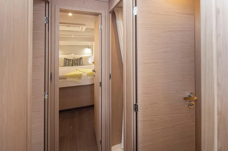 Slide: The Image of 2026 Beneteau Swift Trawler 41 Fly interior cabin with wooden doors and cozy bedroom. - 25