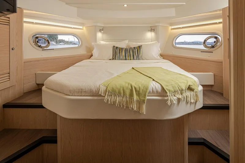 Slide: The Image of Luxurious cabin interior of 2026 Beneteau Swift Trawler 41 Fly with cozy bed and windows. - 26