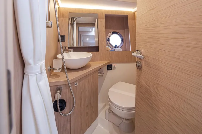 Slide: The Image of Luxurious bathroom in 2026 Beneteau Swift Trawler 41 Fly, featuring modern fixtures and wood accents. - 30