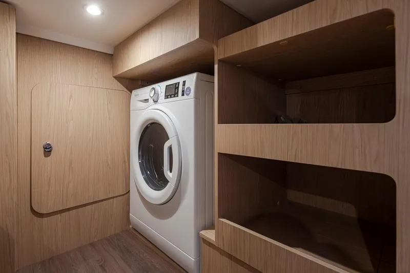 Slide: The Image of Laundry area in 2026 Beneteau Swift Trawler 41 Fly with washer and wooden shelves. - 31