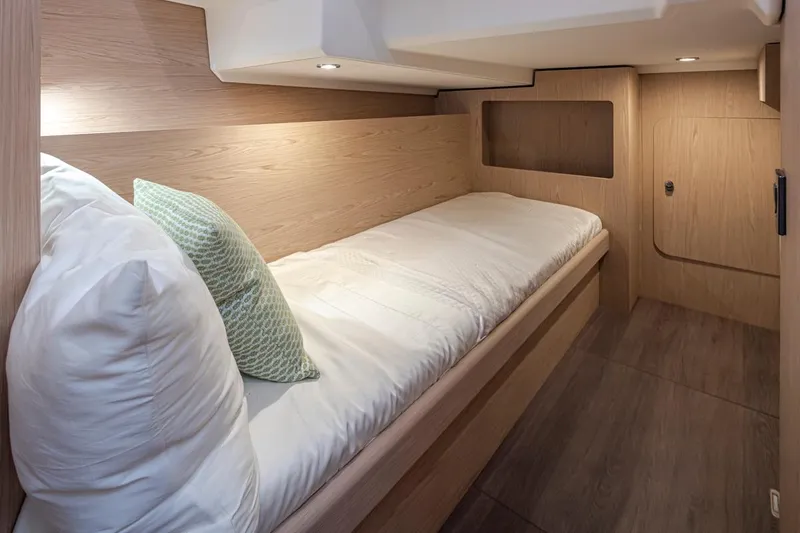 Slide: The Image of Cozy cabin interior of 2026 Beneteau Swift Trawler 41 Fly with wooden finish and bedding. - 33