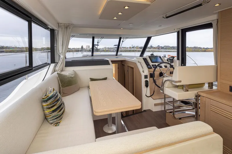 Slide: The Image of Interior of 2026 Beneteau Swift Trawler 41 Fly, featuring modern seating and navigation area. - 5