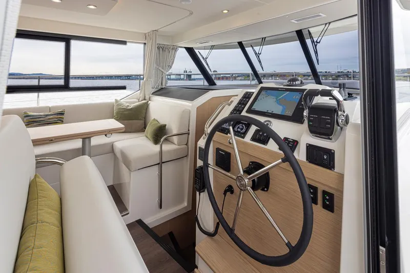 Slide: The Image of 2026 Beneteau Swift Trawler 41 Fly interior with helm, seating, and navigation equipment. - 7