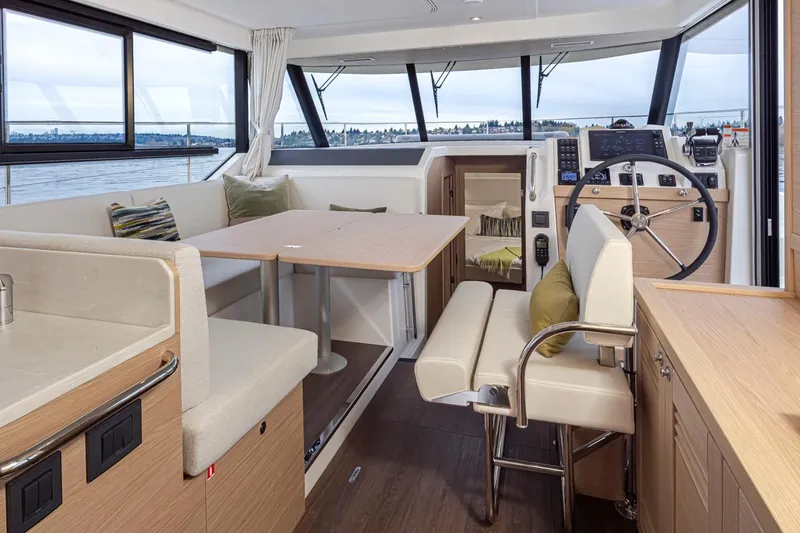 Slide: The Image of Interior of 2026 Beneteau Swift Trawler 41 Fly, featuring helm, seating, and dining area. - 8