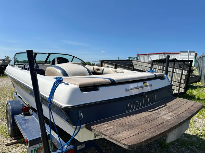 Slide: The Image of 1999 Malibu 20 Response LX boat on trailer under clear blue sky. - 12