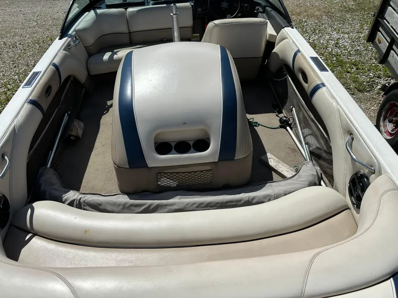 Slide: The Image of 1999 Malibu 20 Response LX boat interior with beige and blue seating. - 2