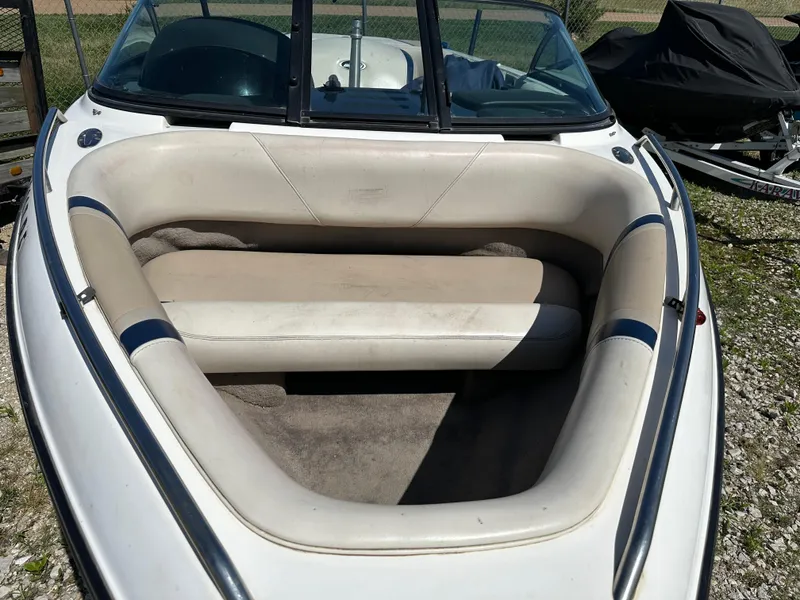 Slide: The Image of 1999 Malibu 20 Response LX boat interior with white and beige seating. - 3