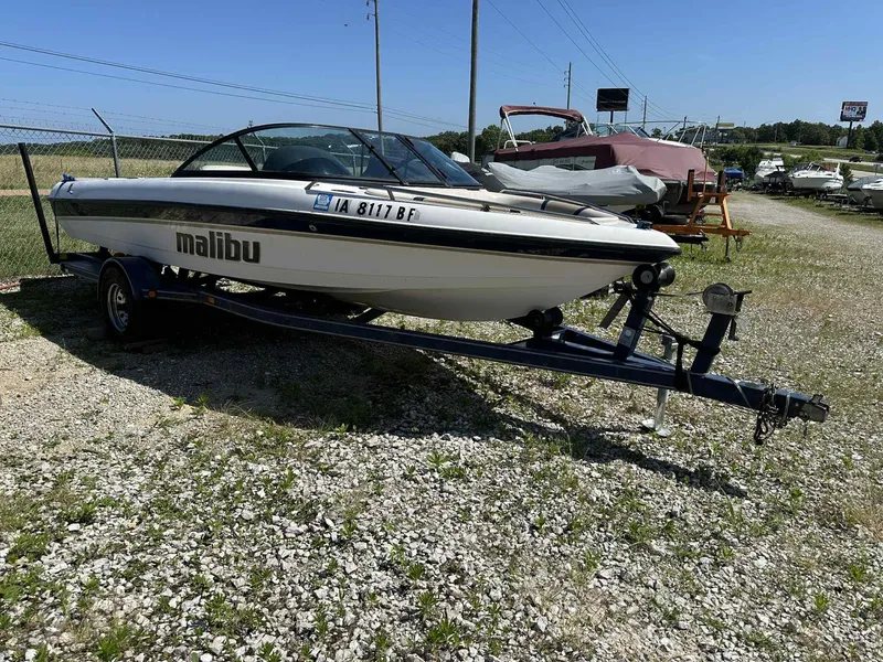 Slide: The Image of 1999 Malibu 20 Response LX boat on trailer in outdoor storage area. - 7