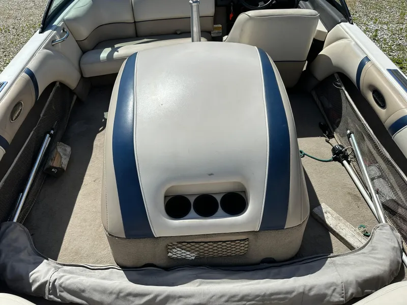 Slide: The Image of 1999 Malibu 20 Response LX boat interior with beige and blue seating. - 8