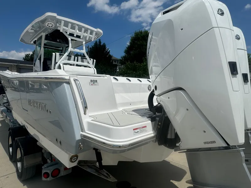 Slide: The Image of 2025 Blackfin 302 CC boat on trailer, rear view with outboard motor. - 11