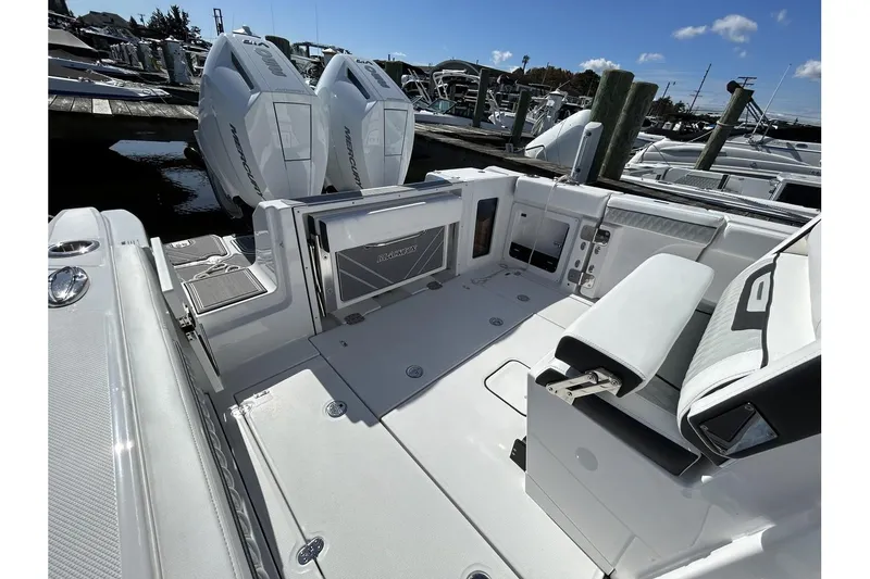 Slide: The Image of 2025 Blackfin 302 CC boat interior with twin outboard engines at a marina. - 5